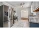 Updated kitchen with stainless steel appliances, white cabinetry, and tile floors for a modern look at 122 William St, Summerville, SC 29486