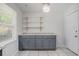 This kitchen features updated cabinets, granite countertops, open shelving, and a window to let in light at 122 William St, Summerville, SC 29486