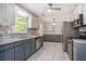 Updated kitchen with stainless steel appliances and grey cabinets, offering ample storage at 122 William St, Summerville, SC 29486