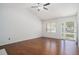 Well-lit living room with hardwood floors, ceiling fan, and access to the front door at 122 William St, Summerville, SC 29486