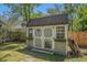 Charming shed with decorative doors, windows, flower boxes, and a sign at 122 William St, Summerville, SC 29486
