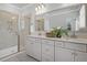 Bright bathroom features a double sink vanity, large mirror, and glass enclosed shower at 123 Brown Swiss Cir, Summerville, SC 29483