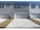 Townhome complex featuring private garages and landscaping at 123 Brown Swiss Cir, Summerville, SC 29483