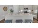Kitchen features quartz island with seating, stainless appliances, and painted cabinets at 123 Brown Swiss Cir, Summerville, SC 29483
