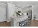 Bright kitchen features a quartz island with seating, stainless appliances and painted cabinets at 123 Brown Swiss Cir, Summerville, SC 29483