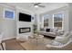 Bright living room featuring modern fireplace, ceiling fan, and comfortable seating arrangements at 123 Brown Swiss Cir, Summerville, SC 29483