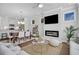 Open-concept living area featuring a fireplace, ceiling fan, and dining space for entertaining at 123 Brown Swiss Cir, Summerville, SC 29483