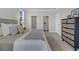 Neutral main bedroom featuring two walk-in closets, a window, and a large bed at 123 Brown Swiss Cir, Summerville, SC 29483