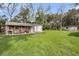 Beautiful backyard with green grass leading to shed with storage area and seating at 1239 Old Orchard Rd, Charleston, SC 29412