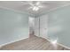 This bedroom features light gray wood floors, two doors, and light blue walls at 1239 Old Orchard Rd, Charleston, SC 29412