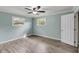 Bedroom featuring windows, a ceiling fan, and light gray wood floors at 1239 Old Orchard Rd, Charleston, SC 29412