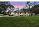 Charming single-story home boasts a well-manicured lawn, flowering bushes, and a paved walkway to the front door at 1239 Old Orchard Rd, Charleston, SC 29412