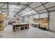 Bright and spacious garage with work benches, storage shelves, and overhead lighting at 1239 Old Orchard Rd, Charleston, SC 29412