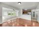 Open-concept living room flowing into the kitchen, featuring hardwood floors and bright light at 1239 Old Orchard Rd, Charleston, SC 29412