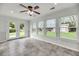 The bright sun room is complete with tiled floors and backyard views at 1239 Old Orchard Rd, Charleston, SC 29412
