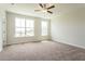 Empty bedroom with carpeted floors, two windows, and a ceiling fan at 125 Brown Swiss Cir, Summerville, SC 29483
