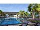 Stunning community pool with clear blue water and surrounding lounge chairs, palm trees, and native landscaping at 125 Brown Swiss Cir, Summerville, SC 29483