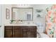 Bathroom featuring a dark wood vanity, a large mirror, and a peach-patterned shower curtain at 132 Daniels Ridge Dr, Summerville, SC 29485