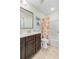 Bright bathroom view features a vanity with dark cabinets and a peach-themed shower curtain at 132 Daniels Ridge Dr, Summerville, SC 29485