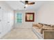 Spacious bedroom featuring a tan sofa, large window, closet doors, and neutral decor at 132 Daniels Ridge Dr, Summerville, SC 29485