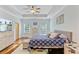 Spacious bedroom featuring tray ceilings, wood floors, a king bed, and plenty of natural light at 132 Daniels Ridge Dr, Summerville, SC 29485