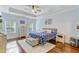 Relaxing bedroom featuring tray ceilings, wood floors, a king bed, and plenty of natural light at 132 Daniels Ridge Dr, Summerville, SC 29485