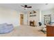 Large bonus room featuring a small electric fireplace, fan and a comfy chair at 132 Daniels Ridge Dr, Summerville, SC 29485