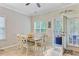 Bright dining area with a table, six chairs, tiled floors, and access to a screened-in porch at 132 Daniels Ridge Dr, Summerville, SC 29485