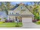 Charming two-story home featuring a well-manicured lawn and welcoming front porch at 132 Daniels Ridge Dr, Summerville, SC 29485