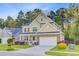 Inviting two-story home with a charming porch, landscaped front yard, and attached garage at 132 Daniels Ridge Dr, Summerville, SC 29485