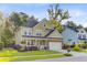 Charming two-story home with a cozy front porch, attached garage, and colorful landscaping enhances curb appeal at 132 Daniels Ridge Dr, Summerville, SC 29485