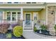 Welcoming front porch with stone accents, featuring decorative plants, flowers, and charming details at 132 Daniels Ridge Dr, Summerville, SC 29485
