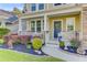 Close-up of the home's inviting front porch with colorful plants and decorations at 132 Daniels Ridge Dr, Summerville, SC 29485