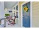 Cozy front porch with rocking chairs and a decorative sunflower wreath on the front door at 132 Daniels Ridge Dr, Summerville, SC 29485
