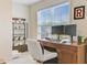 Bright home office space featuring a wooden desk setup, shelving unit, and natural light from a window at 132 Daniels Ridge Dr, Summerville, SC 29485