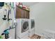 Modern laundry room with a side by side washer and dryer and overhead cabinet storage at 132 Daniels Ridge Dr, Summerville, SC 29485