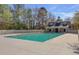 Outdoor community pool with a large pool deck and a covered structure with neutral colors and white picket fence at 132 Daniels Ridge Dr, Summerville, SC 29485