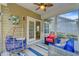Cozy porch with wicker furniture, colorful cushions, and view into the interior dining area at 132 Daniels Ridge Dr, Summerville, SC 29485
