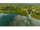 Scenic aerial shot of lakefront property surrounded by lush greenery and lake view reflecting the sky at 133 Hanahan Plantation Cir, Hanahan, SC 29410