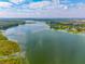 Expansive aerial view of a lake surrounded by trees and a residential area under a blue sky at 133 Hanahan Plantation Cir, Hanahan, SC 29410