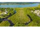Aerial view of waterfront property on wooded lot with mature trees along the river leading to lake at 133 Hanahan Plantation Cir, Hanahan, SC 29410