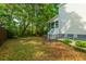 Private backyard with lush greenery and a charming screened porch, providing a serene outdoor retreat at 133 Hanahan Plantation Cir, Hanahan, SC 29410