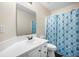 Well-lit bathroom with shower/tub combo and blue patterned curtain at 133 Hanahan Plantation Cir, Hanahan, SC 29410