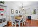 Sunlit dining area boasts wood floors, stylish light fixture, and backyard access at 133 Hanahan Plantation Cir, Hanahan, SC 29410