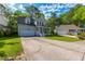 Inviting two-story home with a garage, charming front porch, and well-manicured lawn in a desirable neighborhood at 133 Hanahan Plantation Cir, Hanahan, SC 29410