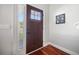 Inviting foyer with hardwood floors, a stylish front door, and natural light streaming through a window at 133 Hanahan Plantation Cir, Hanahan, SC 29410