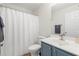 Well-lit bathroom featuring a blue vanity and a shower with a white shower curtain at 1362 Palm Cove Dr, Charleston, SC 29492