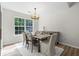 Cozy dining room with modern chandelier, wood table, and bright natural light at 1362 Palm Cove Dr, Charleston, SC 29492