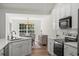 Modern kitchen with white cabinets, stainless appliances, and open layout to dining area at 1362 Palm Cove Dr, Charleston, SC 29492