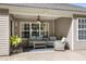 Cozy covered patio with comfortable seating, ceiling fan, and view of the backyard at 1362 Palm Cove Dr, Charleston, SC 29492